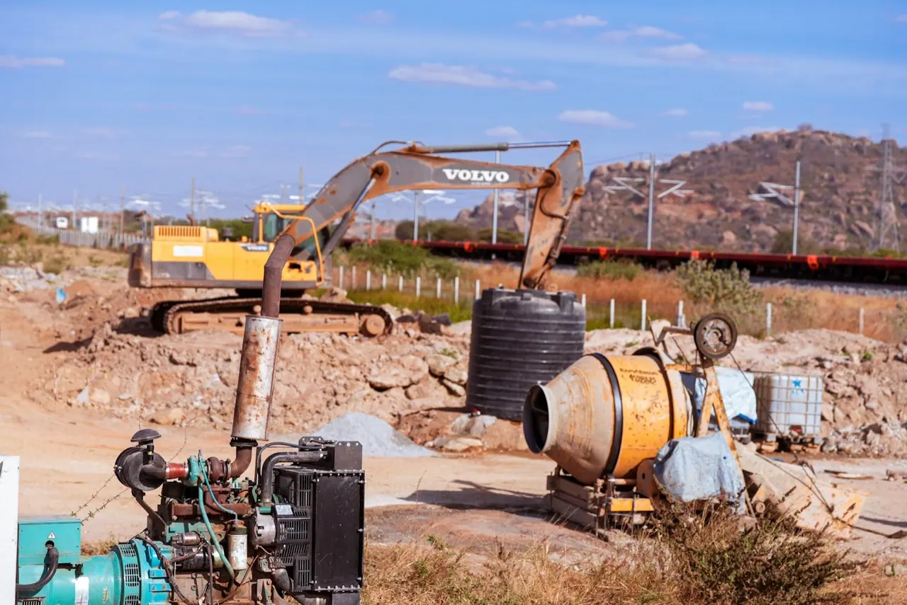 Construction site with an excavator, a concrete mixer and a generator