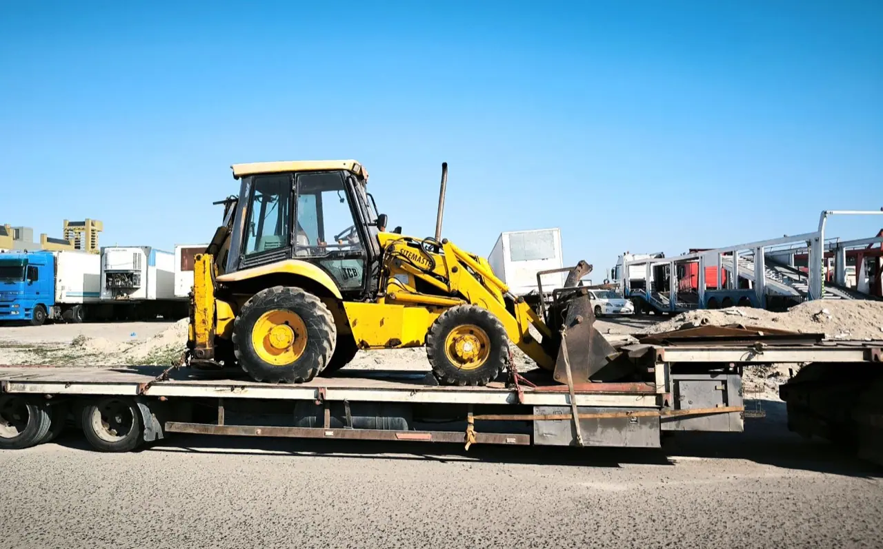 Heavy equipment carried on a flatbed trailer