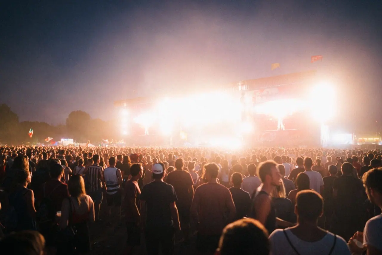 Outdoor music festival stage with lights and a crowd