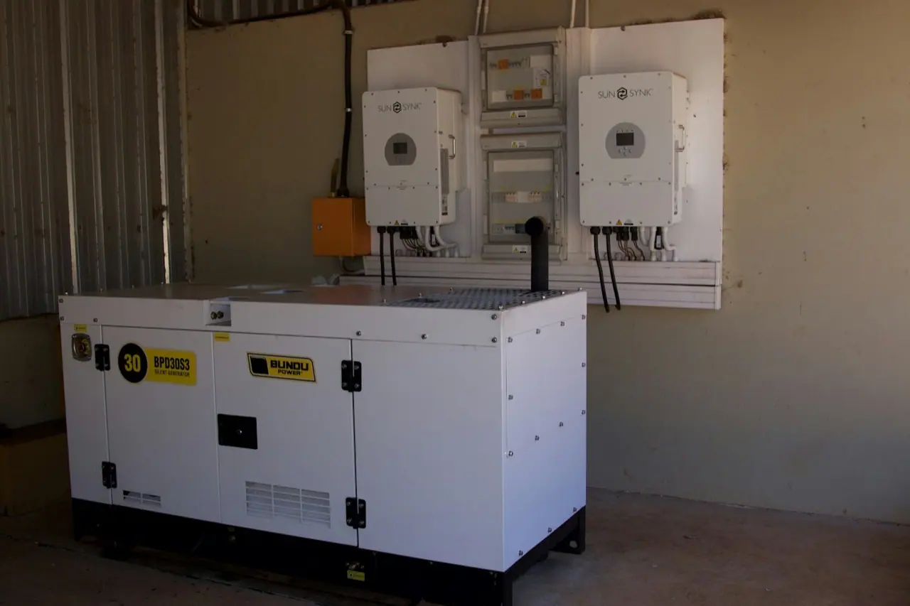 White canopy diesel generator set of the 30 kVA class with control panel